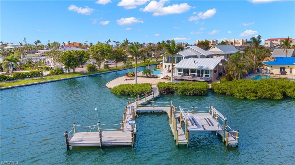 21521 Madera Road Fort Myers Beach, FL 33931 - Photo 3 of 45 an aerial view of a house with swimming pool garden view and a lake view