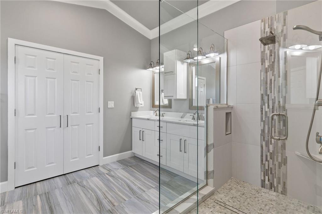 21521 Madera Road Fort Myers Beach, FL 33931 - Photo 31 of 45 a bathroom with a double vanity sink a shower and a mirror