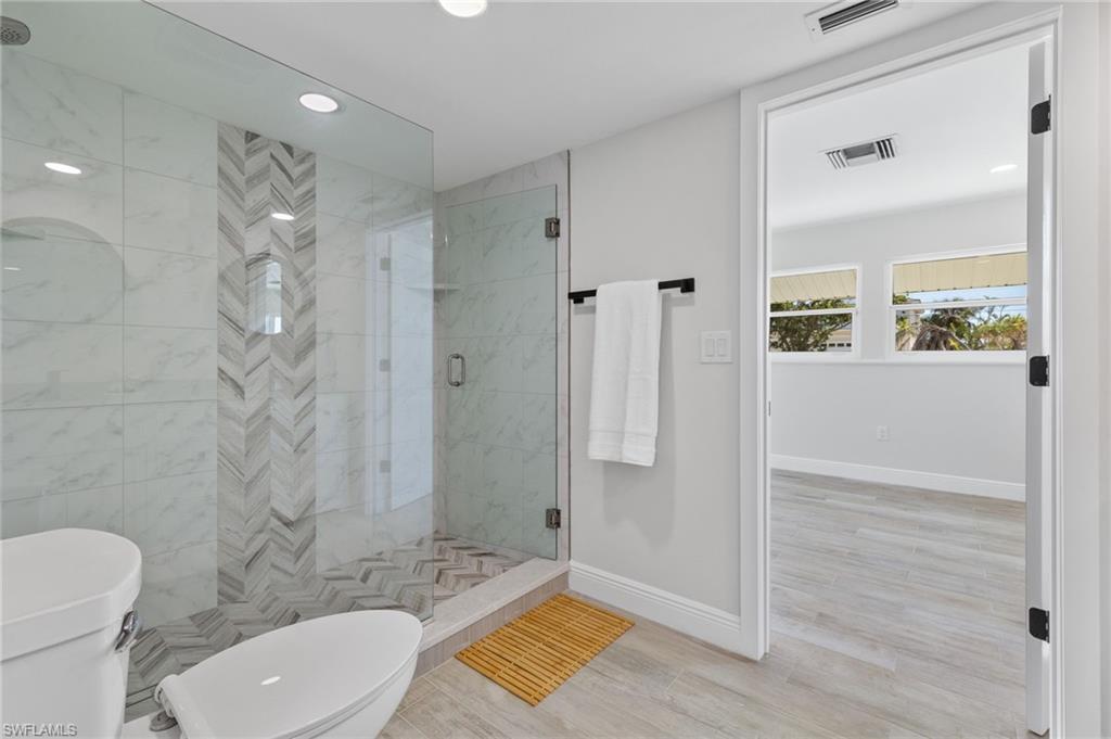 21521 Madera Road Fort Myers Beach, FL 33931 - Photo 39 of 45 a bathroom with a toilet a sink and shower