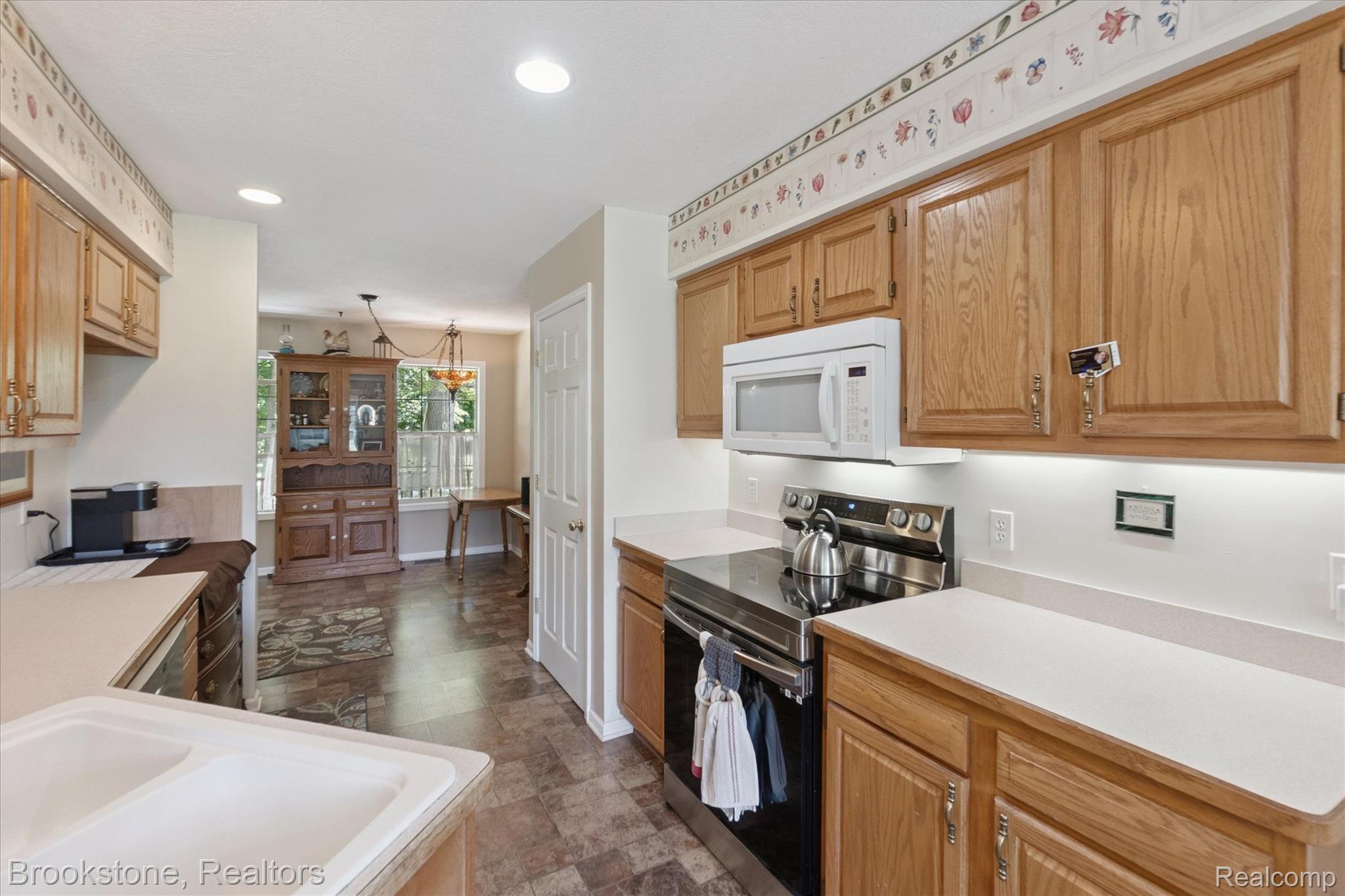 13962 South Beardslee Road Perry, MI 48872 - Photo 18 of 56 Kitchen with electric stove, light countertops, recessed lighting, decorative light fixtures, and stone finish flooring