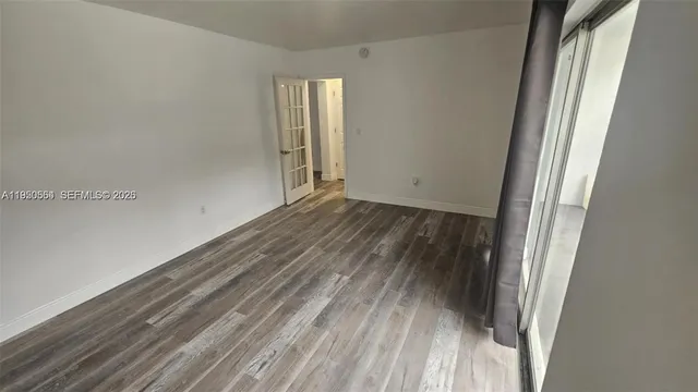 a view of a room with wooden floor