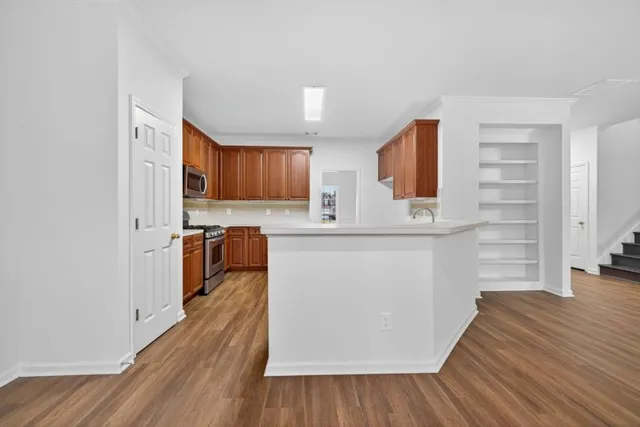 a view of a kitchen with a sink cabinet a kitchen and a window