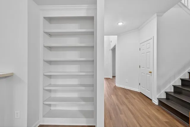 a view of an entryway with wooden floor and staircase