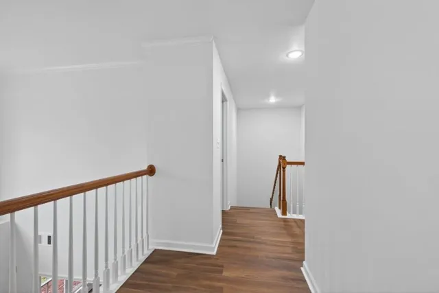a view of a room with wooden floor and a ceiling fan