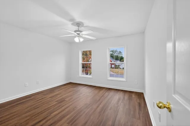 wooden floor in an empty room with a window