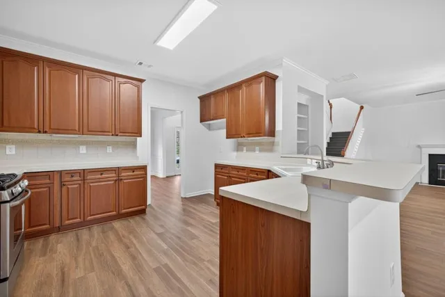 a kitchen with a sink stove and cabinets