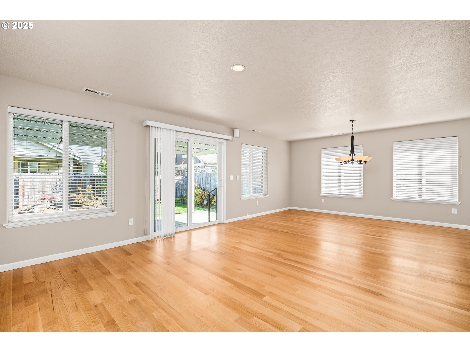 1176 Unity Drive Junction City, OR 97448 - Photo 15 of 44 a view of an empty room with wooden floor and a window