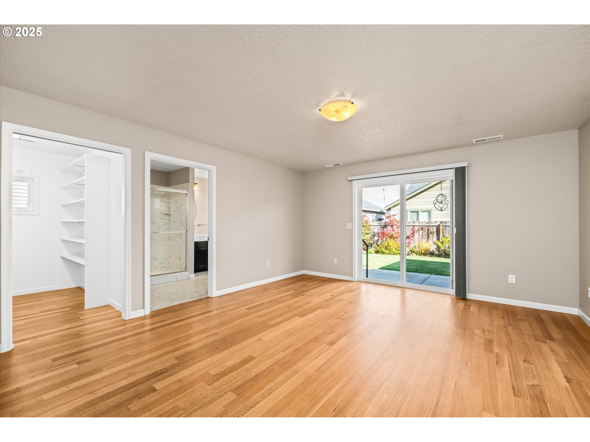 1176 Unity Drive Junction City, OR 97448 - Photo 18 of 44 a view of an empty room with wooden floor and a window