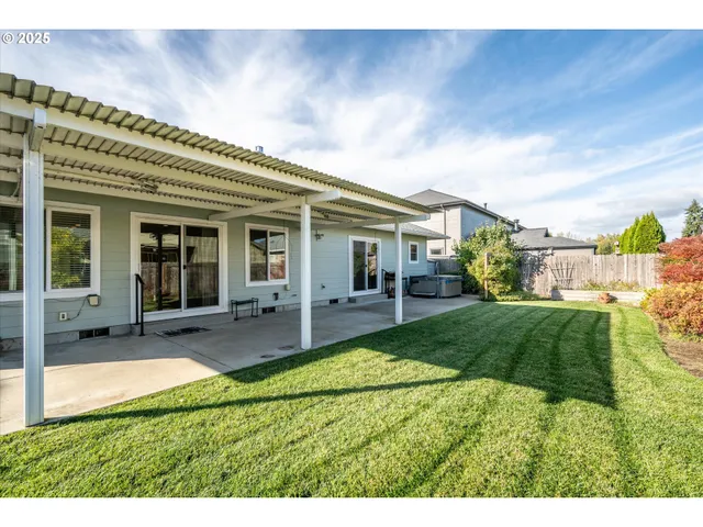 a view of a house with backyard porch and sitting area