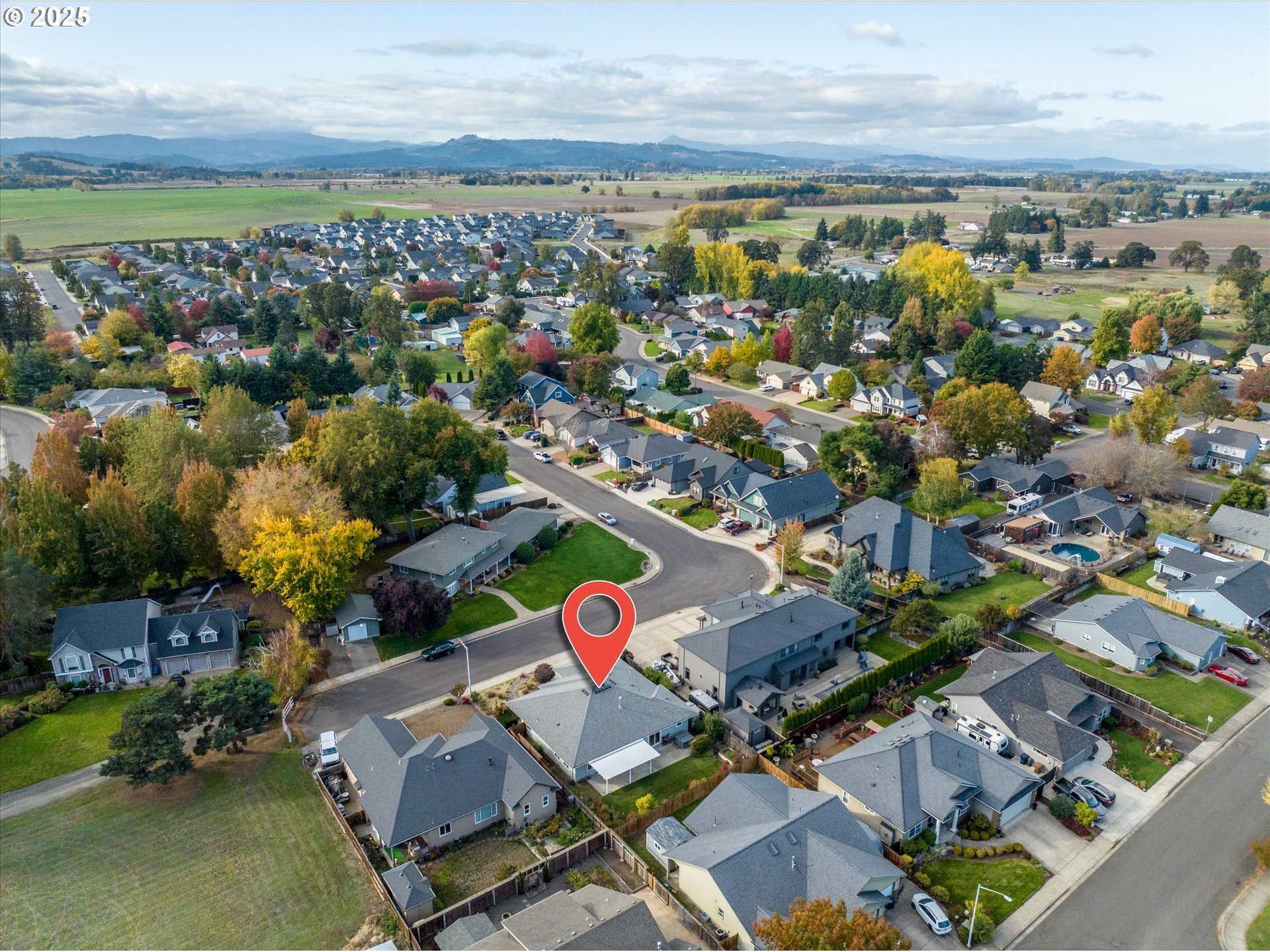 1176 Unity Drive Junction City, OR 97448 - Photo 39 of 44 an aerial view of a city with lots of residential buildings ocean and mountain view in back