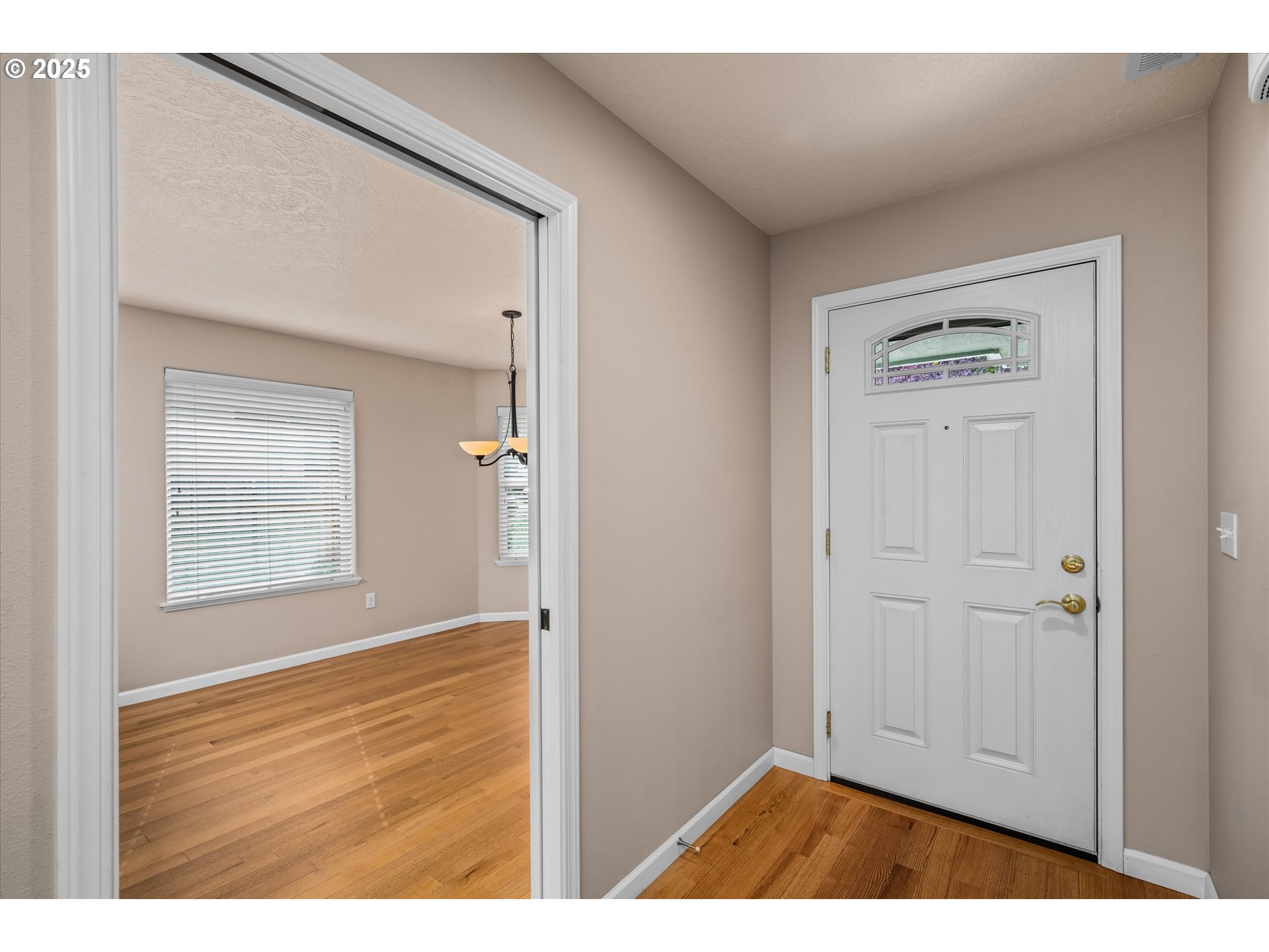 1176 Unity Drive Junction City, OR 97448 - Photo 5 of 44 a view of an empty room with wooden floor and a window