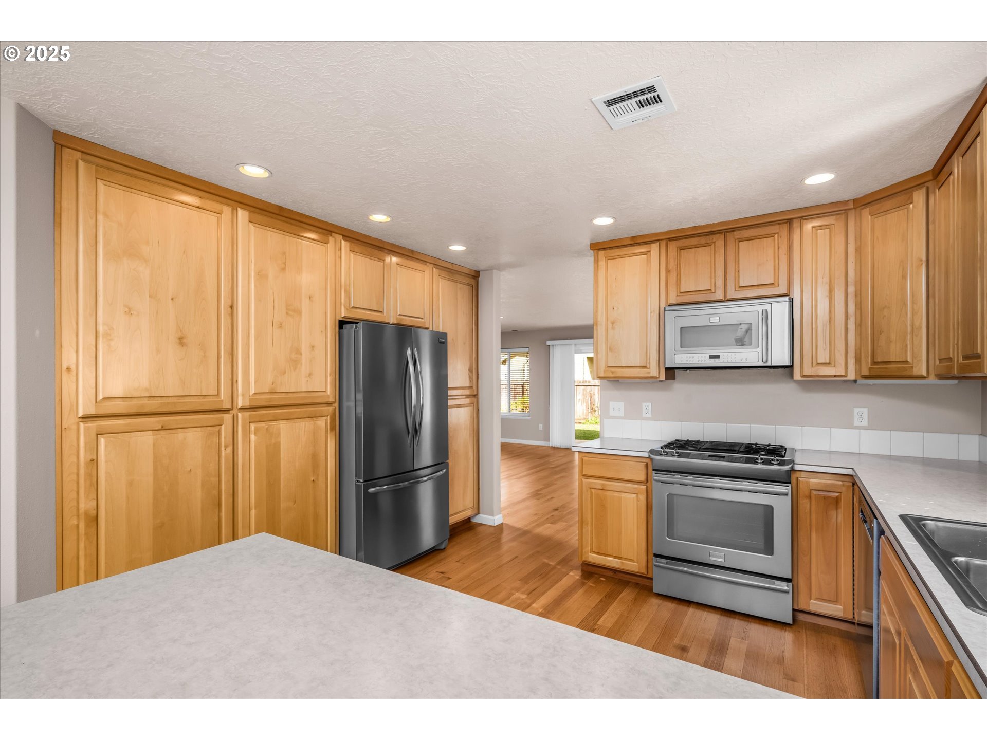 1176 Unity Drive Junction City, OR 97448 - Photo 6 of 44 a kitchen with refrigerator cabinets and a counter top space