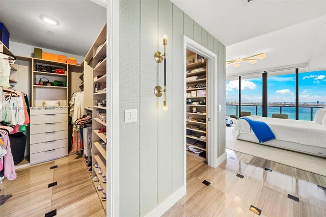 a bedroom with a bed and a flat tv screen on dresser