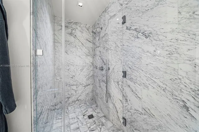 a bedroom with furniture and large windows