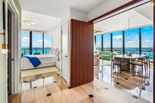 a kitchen with sink refrigerator and large window