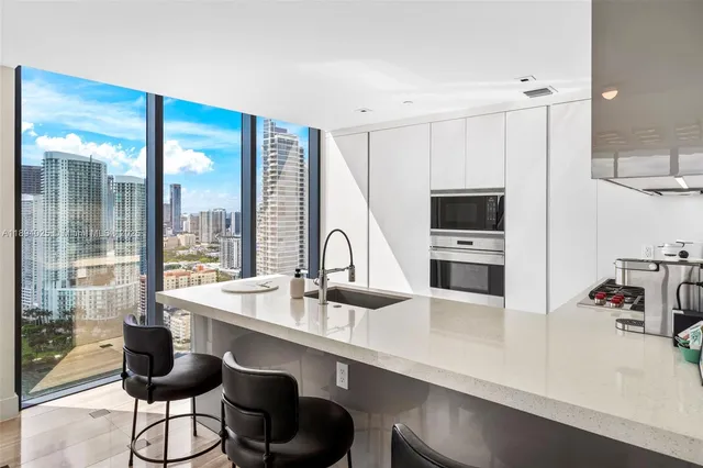 a kitchen with a sink stove and cabinets