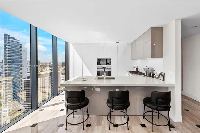 a bathroom with a glass door shower and a sink