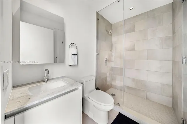 a bedroom with a bed and glass window