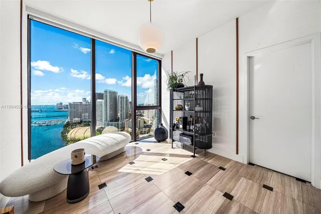 a living room with furniture and a floor to ceiling window