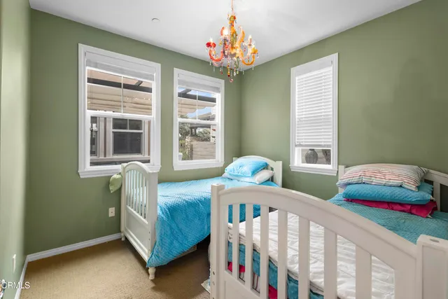 a bedroom with two beds and a window