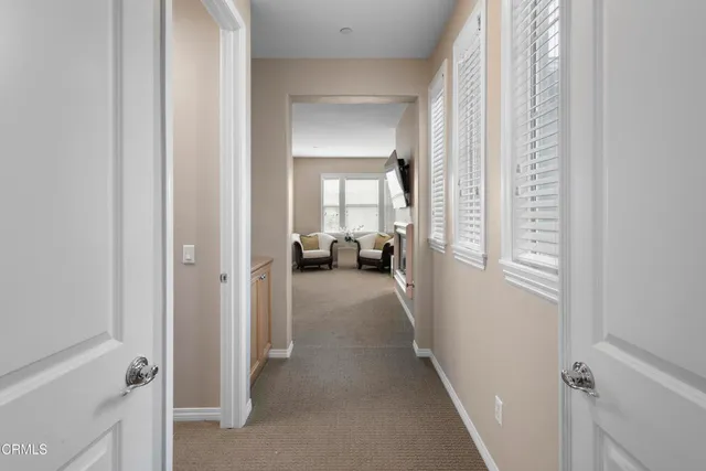 a view of a hallway with closet and a livingroom view