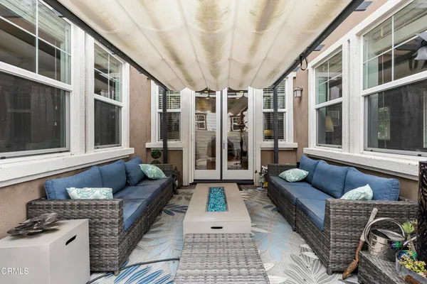 a balcony with furniture and next to a window