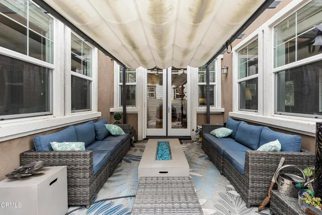 a balcony with furniture and next to a window