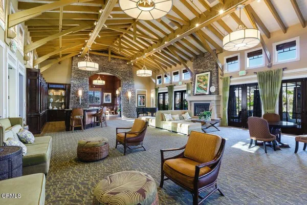 a living room with furniture a wooden floor and a chandelier