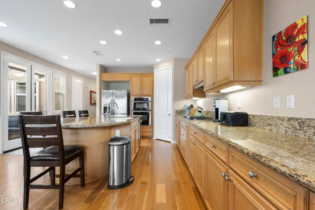 a large kitchen with lots of counter space and stainless steel appliances