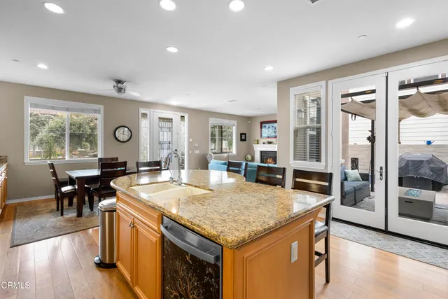 a kitchen with granite countertop center island and stainless steel appliances