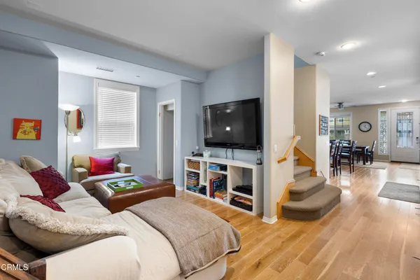 a bedroom with furniture and a flat screen tv