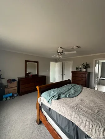 a bedroom with a bed and a dresser