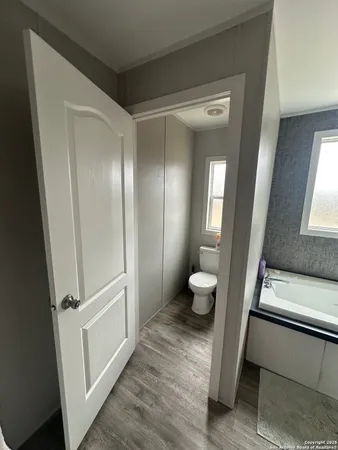 a bathroom with a toilet and a mirror