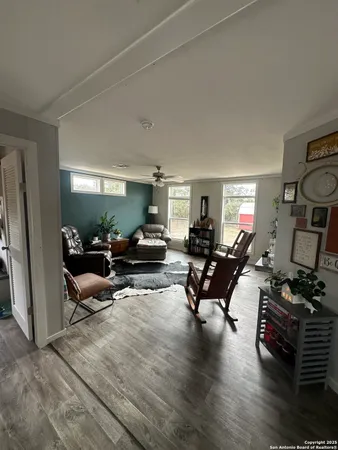 a living room with furniture window and a flat screen tv
