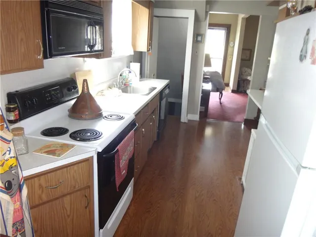 a kitchen with a stove a sink and a refrigerator