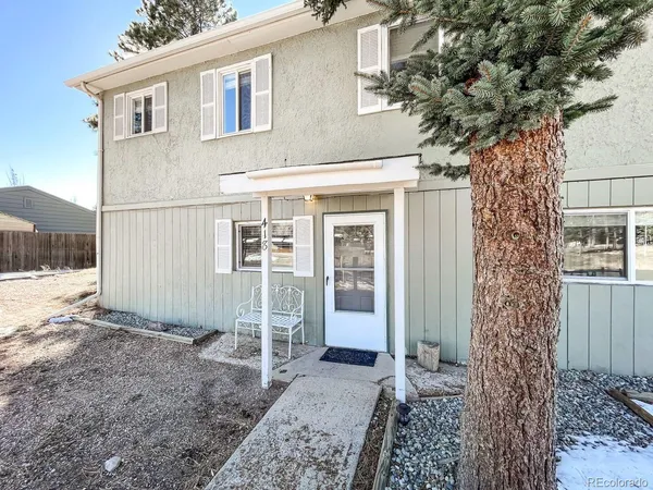 a view of a house with a tree