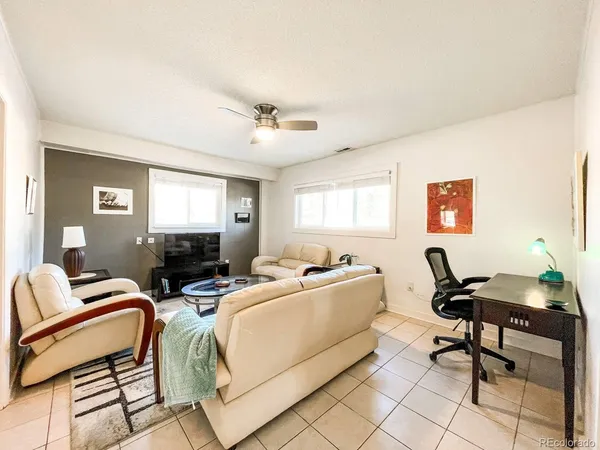 a living room with furniture a window and a flat screen tv