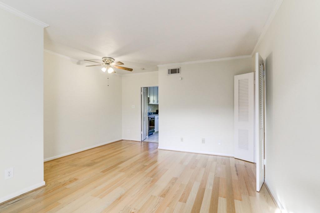 91 Rumson Road Northeast, Unit C35 Atlanta, GA 30305 - Photo 2 of 12 an empty room with wooden floor and fan