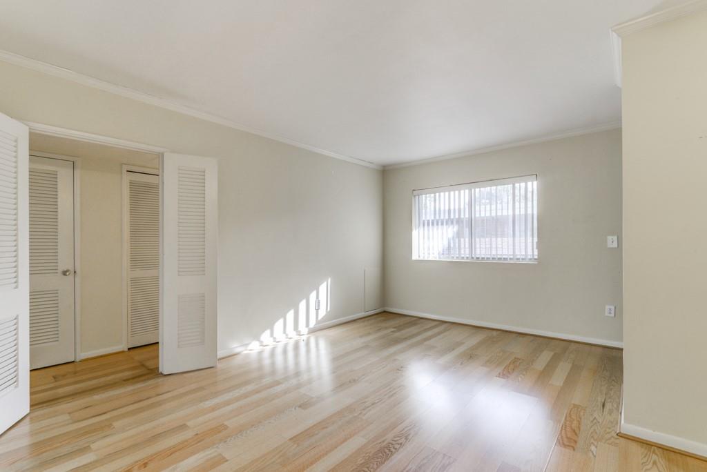 91 Rumson Road Northeast, Unit C35 Atlanta, GA 30305 - Photo 3 of 12 a view of an empty room with wooden floor and a window