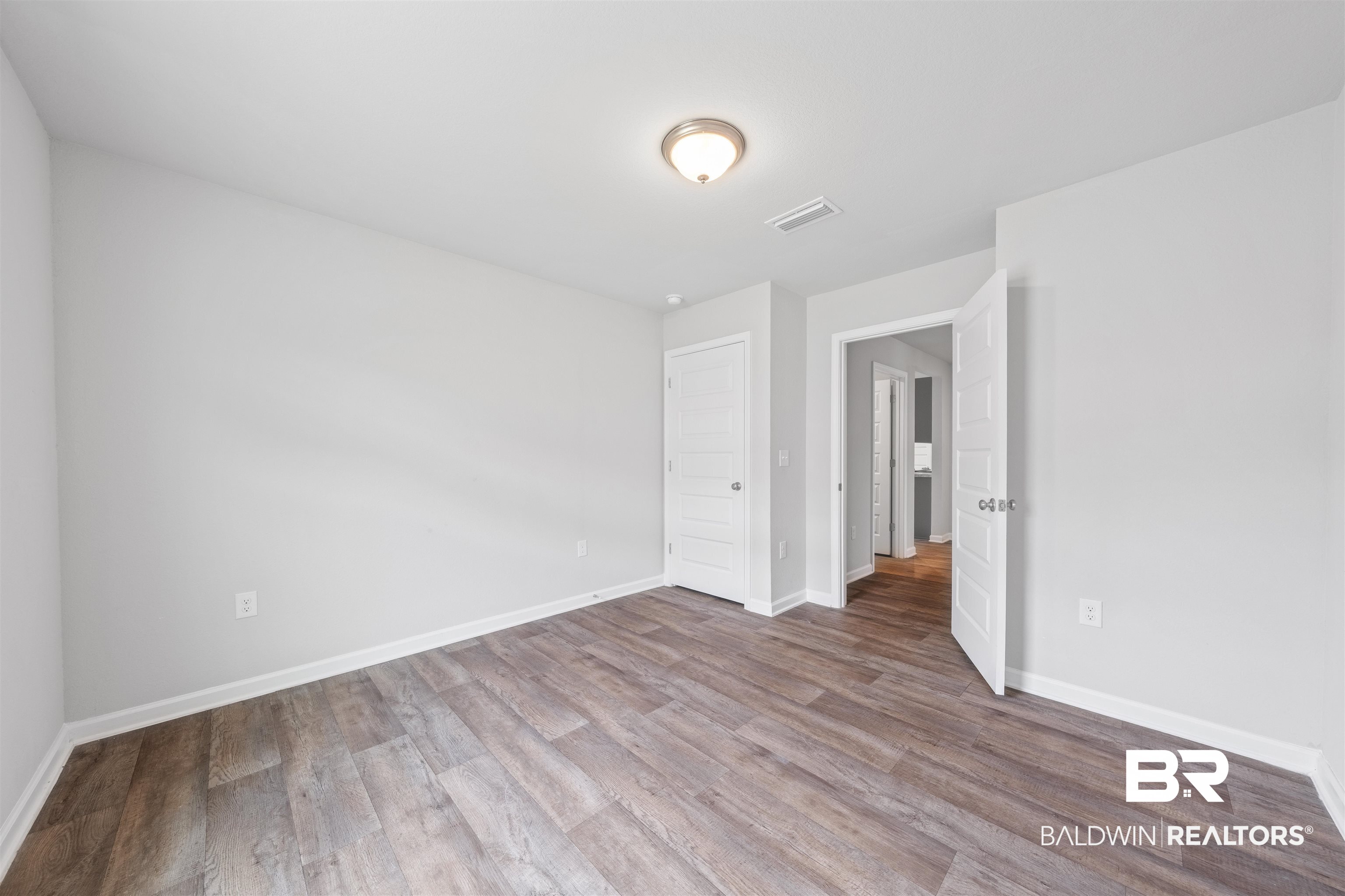 7457 Brompton Drive Foley, AL 36535 - Photo 22 of 24 Unfurnished room featuring light wood-style floors and baseboards