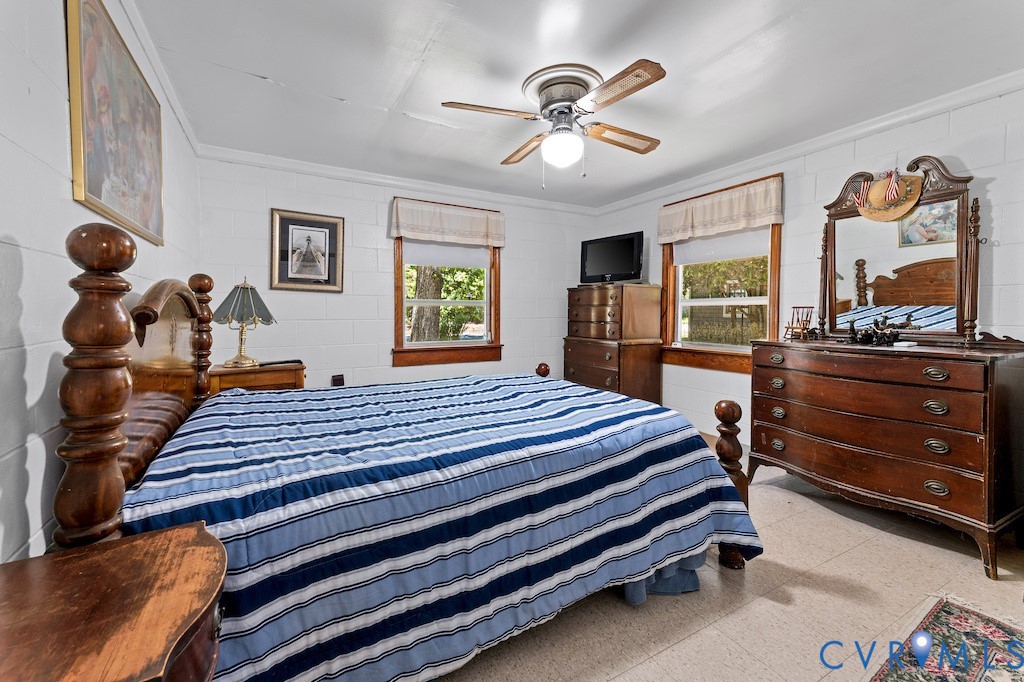 214 Davis Drive Reedville, VA 22539 - Photo 11 of 22 a bedroom with a bed and a chandelier