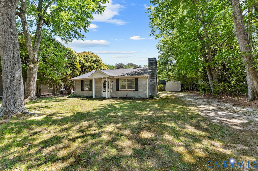 214 Davis Drive Reedville, VA 22539 - Photo 3 of 22 a front view of a house with a garden
