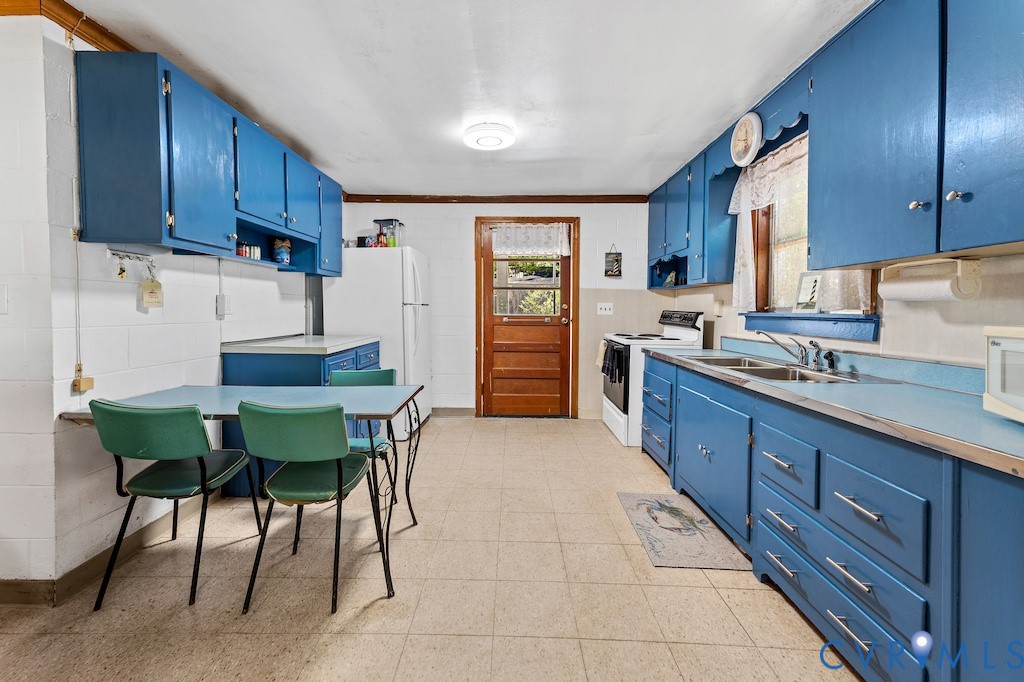 214 Davis Drive Reedville, VA 22539 - Photo 8 of 22 a kitchen with a table chairs sink and cabinets