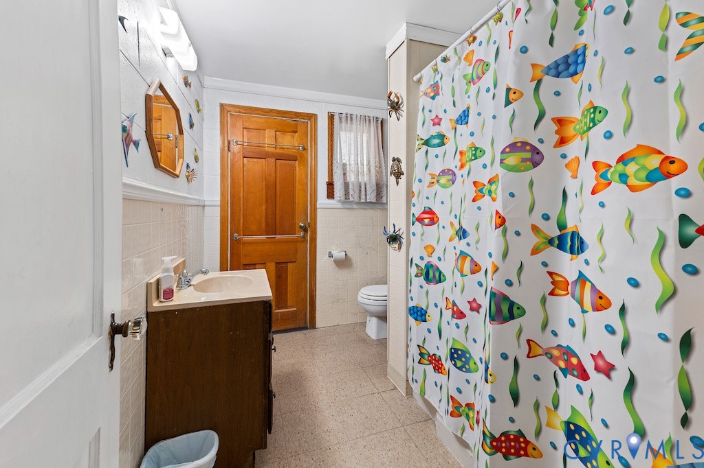 214 Davis Drive Reedville, VA 22539 - Photo 9 of 22 a bathroom with a sink a toilet and shower curtain