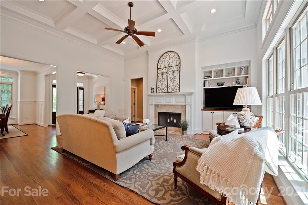 145 Huntington Ridge Place Mooresville, NC 28115 - Photo 12 of 45 a living room with furniture a fireplace and a flat screen tv