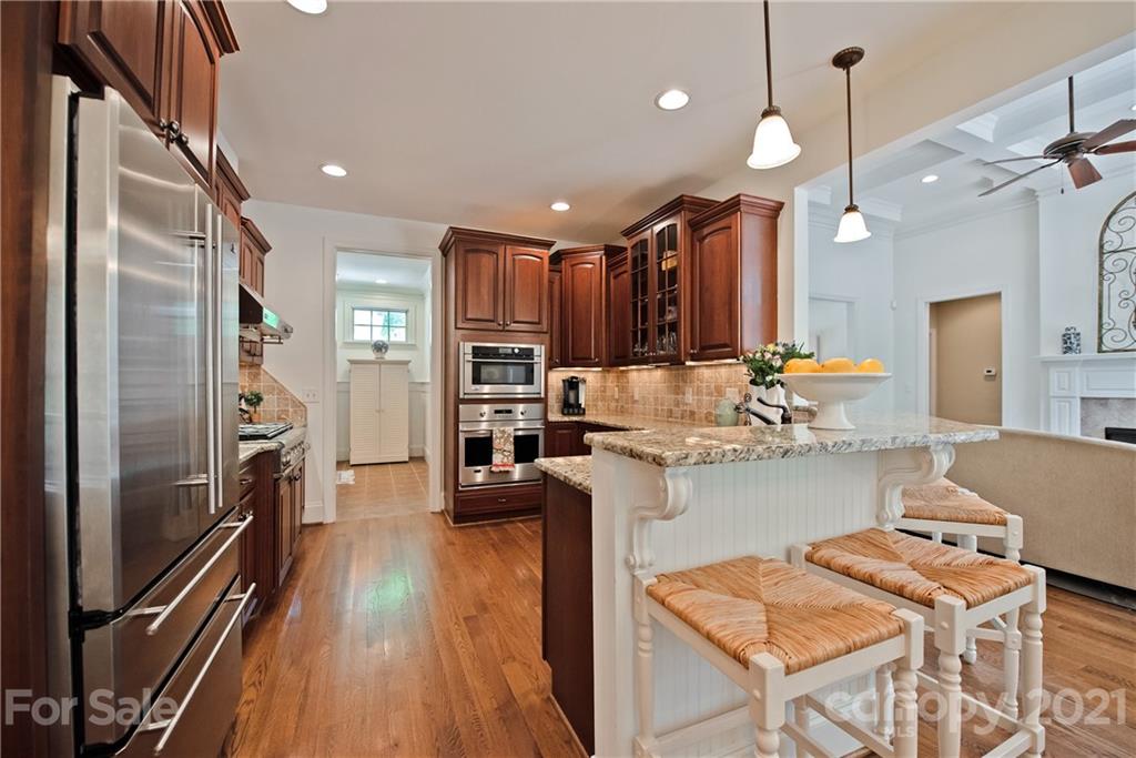 145 Huntington Ridge Place Mooresville, NC 28115 - Photo 15 of 45 a kitchen with refrigerator and cabinets
