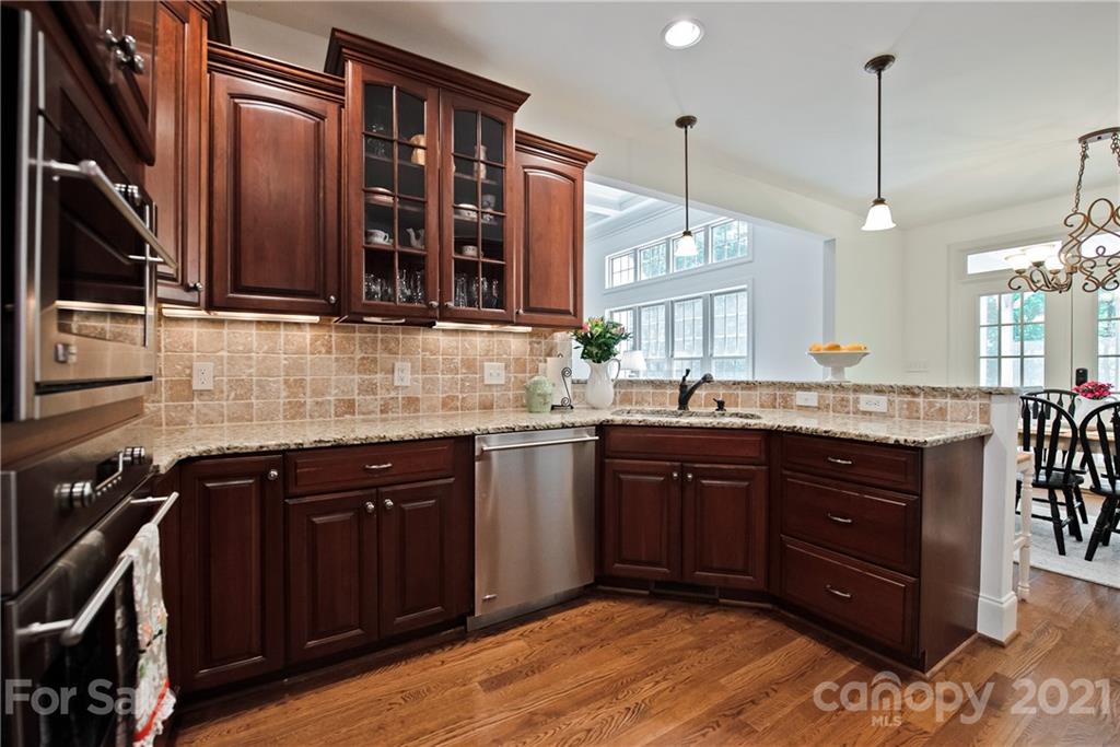 145 Huntington Ridge Place Mooresville, NC 28115 - Photo 18 of 45 a kitchen with a sink and a wooden cabinets