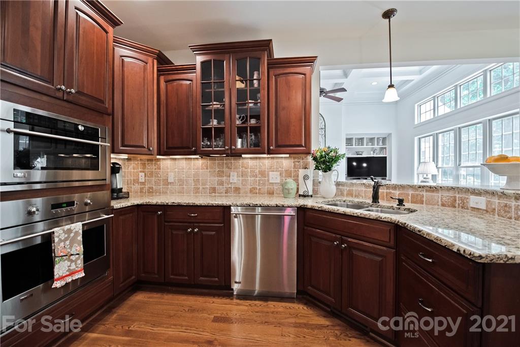 145 Huntington Ridge Place Mooresville, NC 28115 - Photo 19 of 45 a kitchen with stainless steel appliances granite countertop a sink stove and cabinets