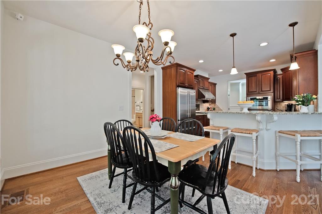 145 Huntington Ridge Place Mooresville, NC 28115 - Photo 20 of 45 a view of a dining room with furniture wooden floor and chandelier