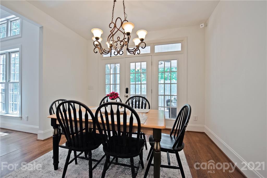 145 Huntington Ridge Place Mooresville, NC 28115 - Photo 21 of 45 a view of a dining room with furniture a chandelier and wooden floor